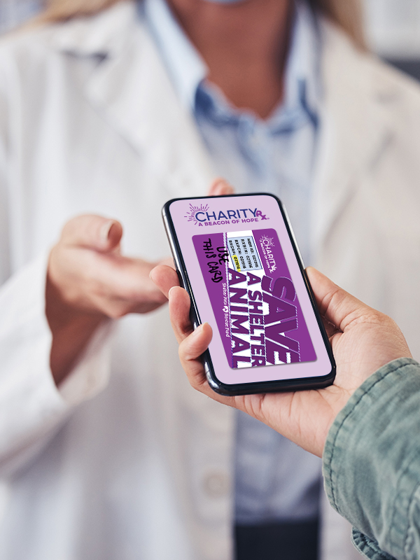 Image of a person's hand passing a smart phone to a pharmacist with an image of the CharityRx discount card on the screen.