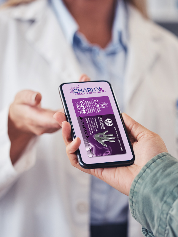 Image of a person handing their smart phone to a pharmacist. The image on the phone is the CharityRx prescription discount card.