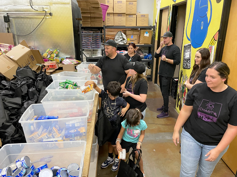 A group of CharityRx team members sort donations into bins at Project 150.