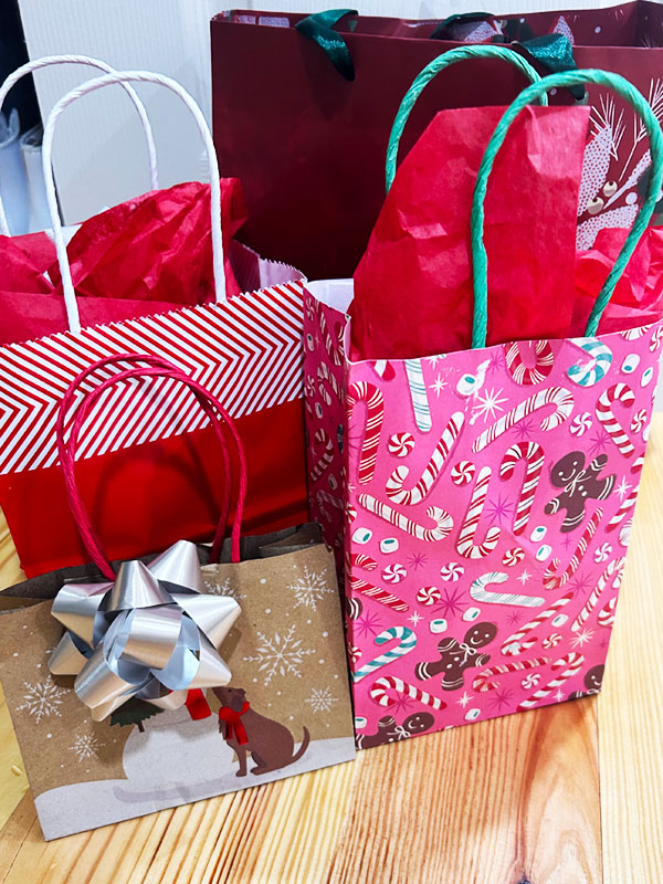 Festive gift bags displayed on a table.